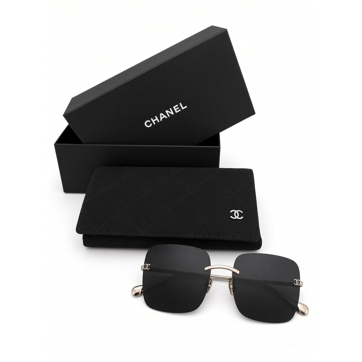 $900 | Chanel CH4287T square titanium sunglasses
Light gold / silver titanium · gray lenses