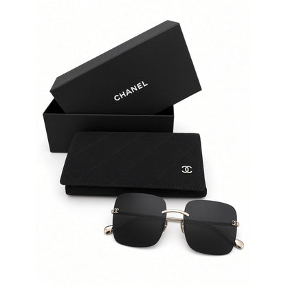 $900 | Chanel CH4287T square titanium sunglasses
Light gold / silver titanium · gray lenses