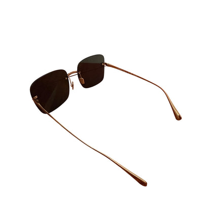 $900 | Chanel CH4287T square titanium sunglasses
Light gold / silver titanium · gray lenses